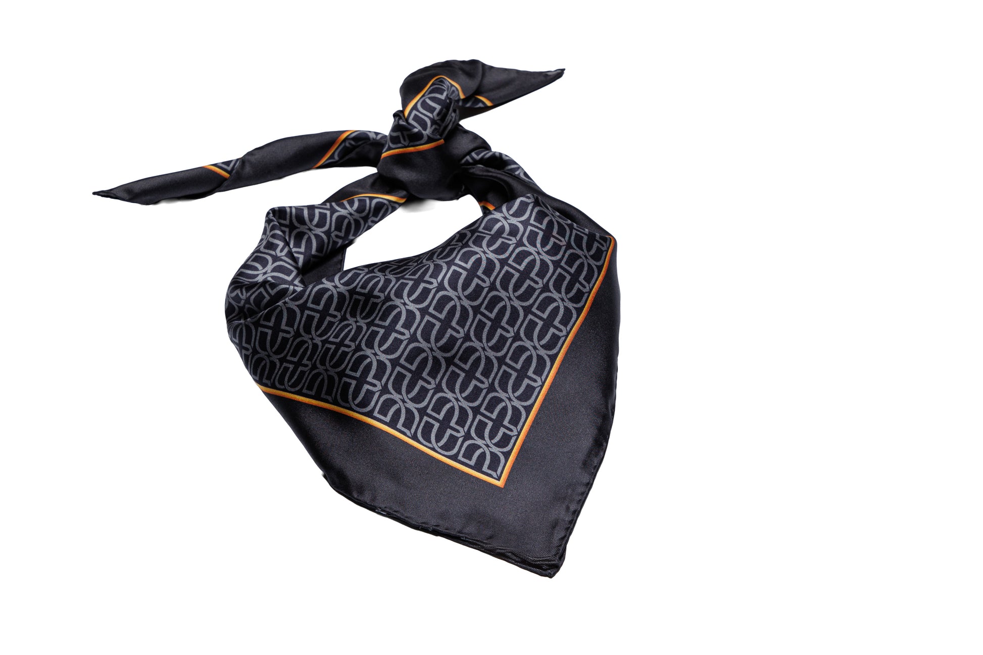 A black silk neck scarf featuring a repeating white monogram pattern and a thin orange border, tied in a knot against a solid white background.