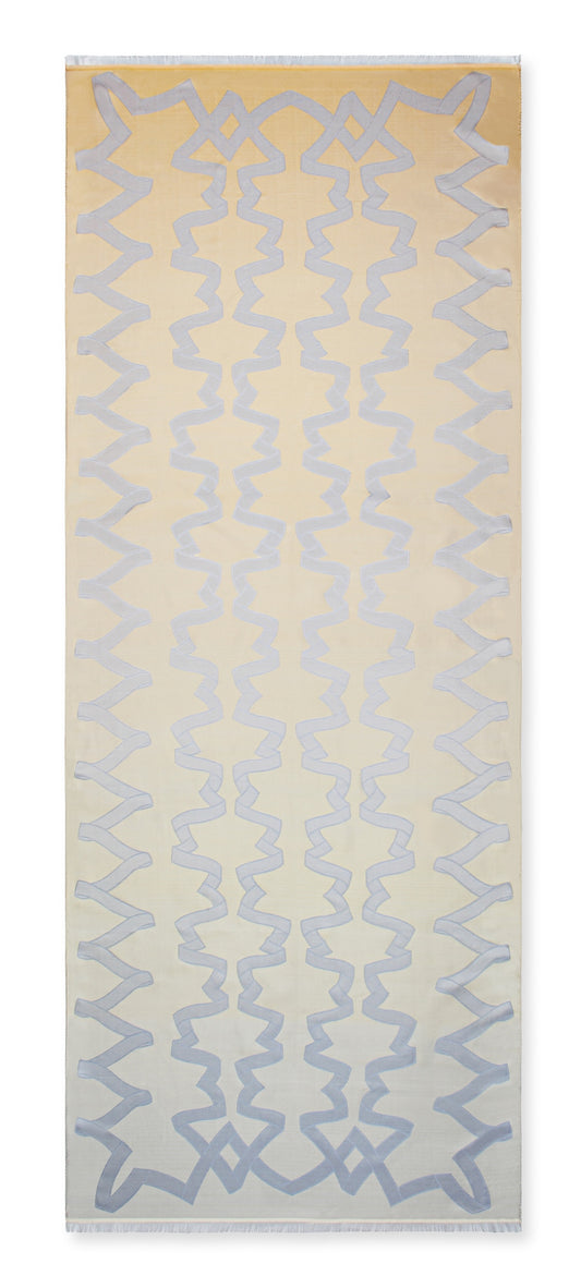 A rectangular area rug with a cream and beige background featuring a repeating vertical pattern of light blue geometric zigzag and star-like motifs.